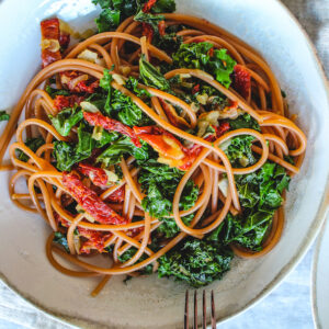 Tuscan Kale tomato Pasta with red lentil pasta and sun-dried tomatoes. Served with homemade Italian herbed sauces.